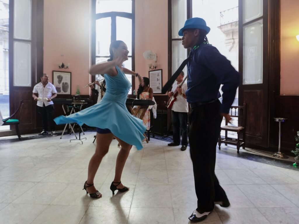 A couple dancing closely indoors while a live band plays, like a 1940s swing dance hall