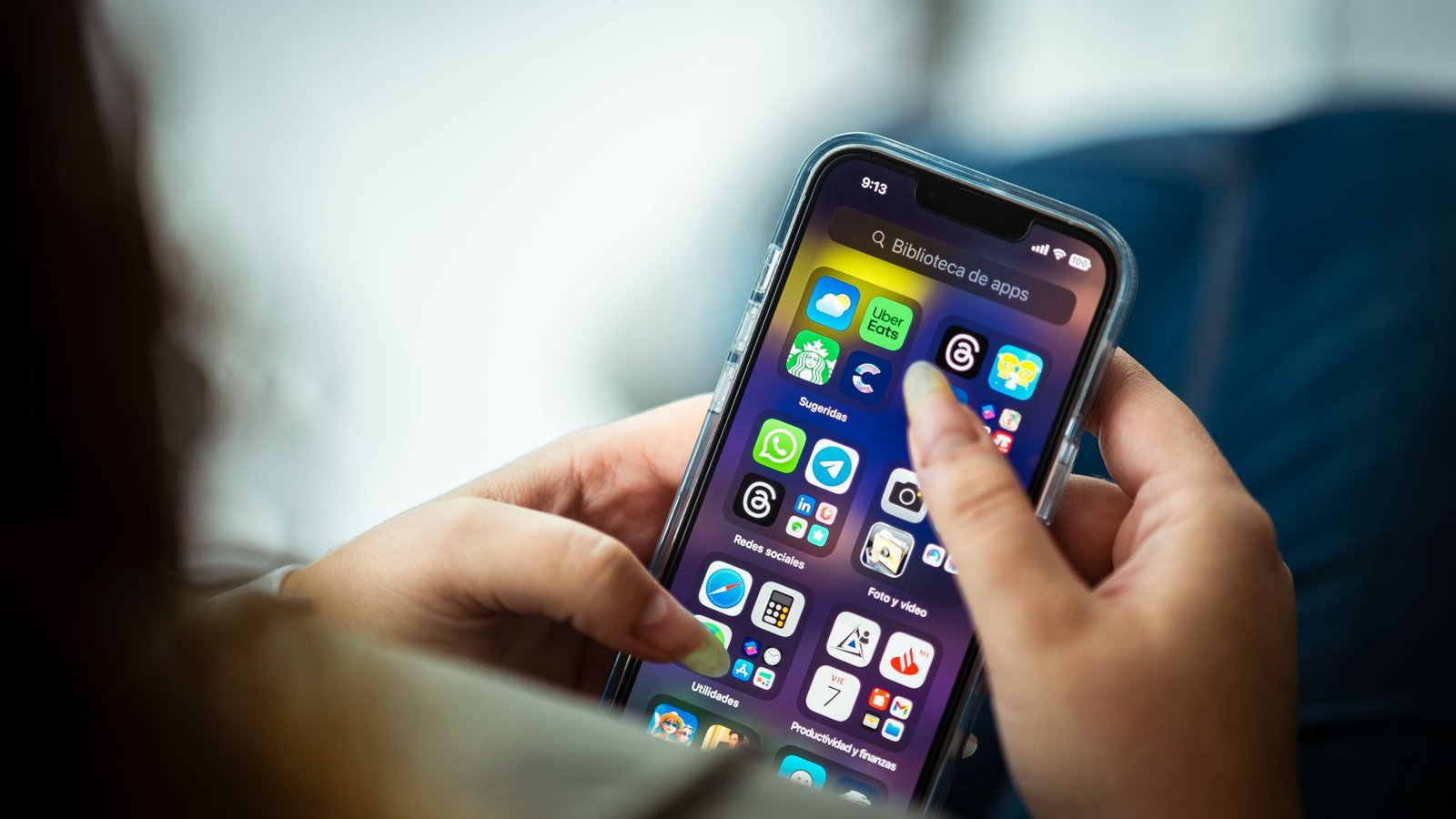 Person holding a smartphone with social media apps