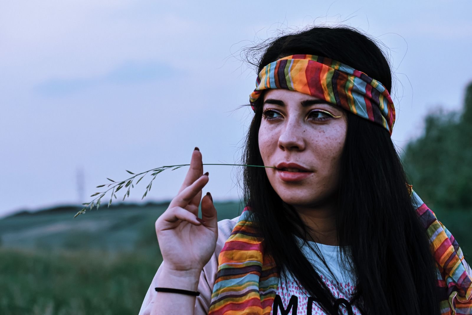 Woman wearing a colorful headband in a green meadow