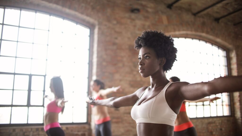Confident woman in activewear training at a bright fitness studio