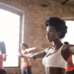 Confident woman in activewear training at a bright fitness studio