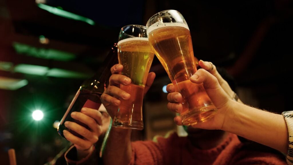 friends toasting beer glasses in a lively pub setting