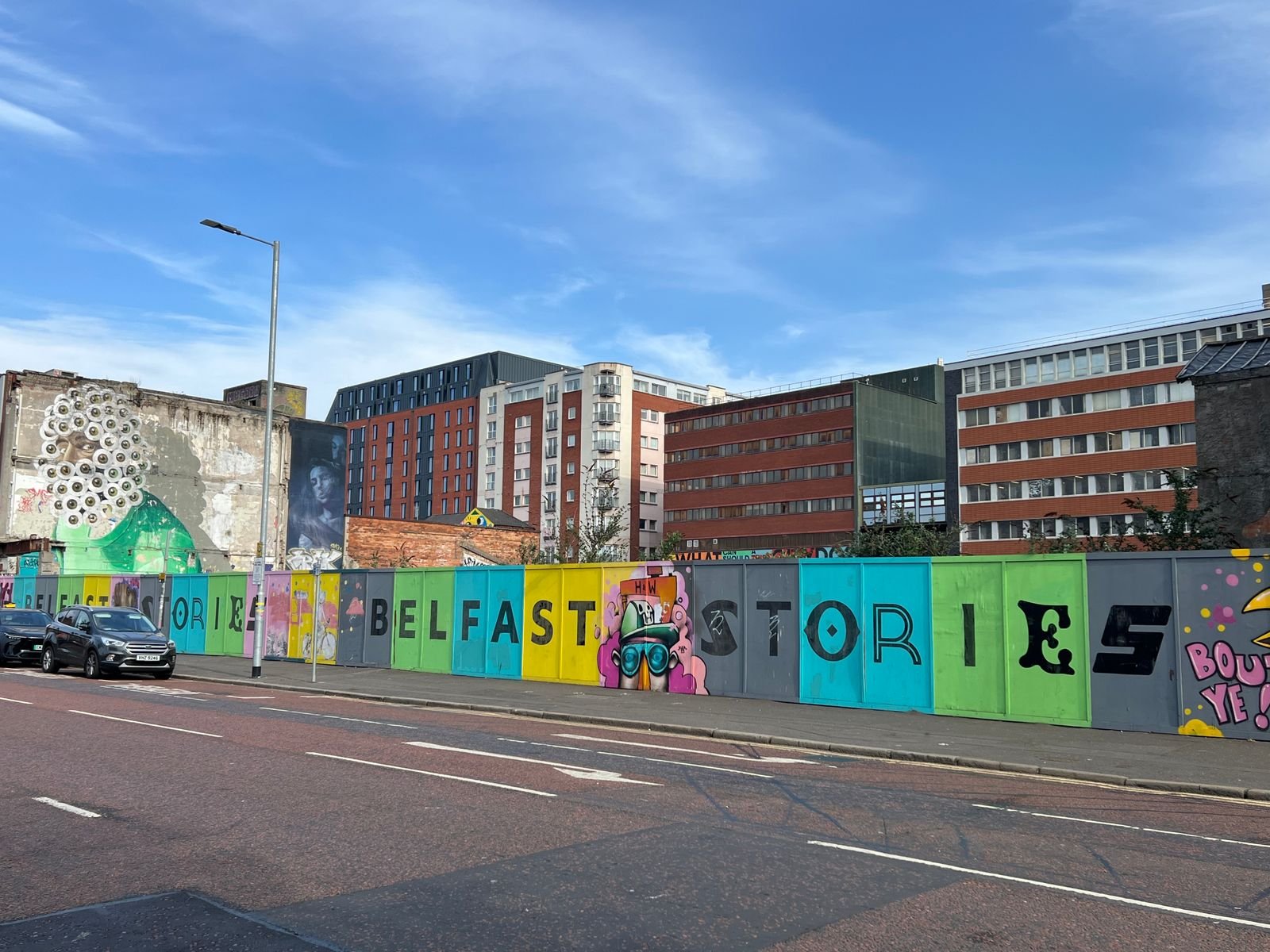 Colorful street art on a wall in Belfast city centre.